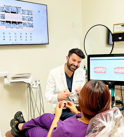 Dr. Jeffrey Proniloff speaking to a patient about their oral health